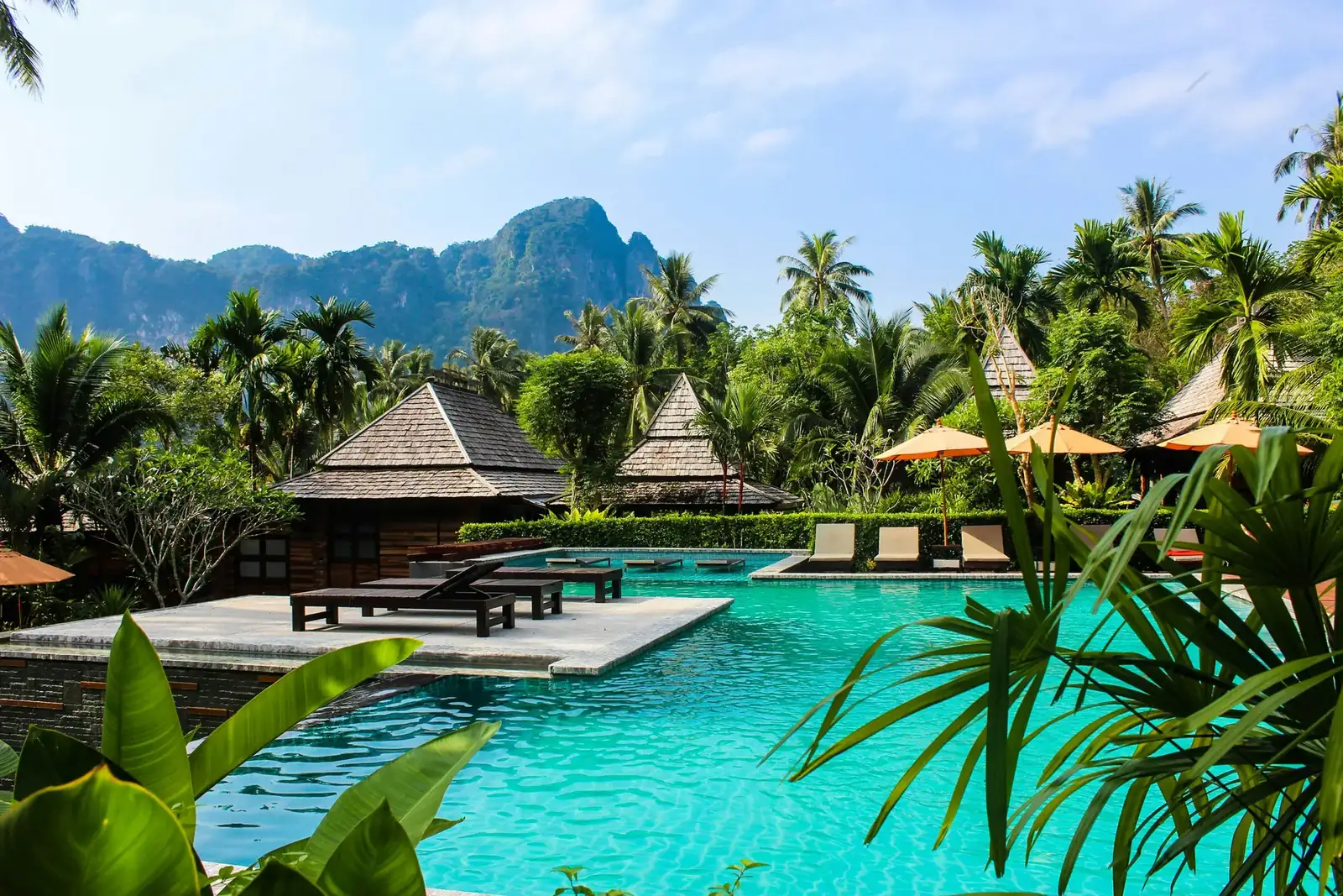 Resort com piscinas e bangalôs entre montanhas e vegetação